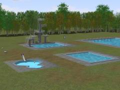 Freibad mit Sprungturm, Schwimmbecken, Duschbecken und Eingangsgebude.